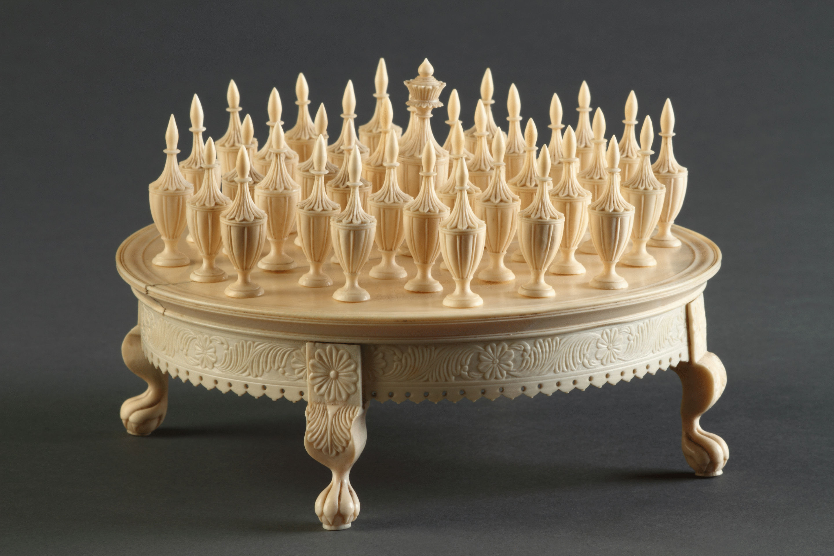 Indian Moghul Carved Ivory Solitaire Game Board with Thirty-Six Vase Shaped Pieces and one Large Central Peg